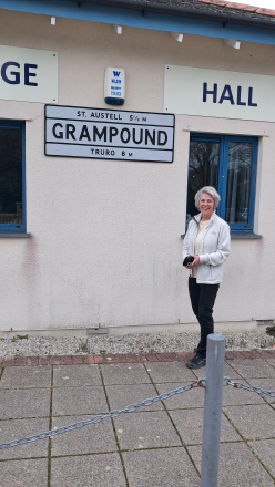 Liz Fisher in front of the newly elected sign.